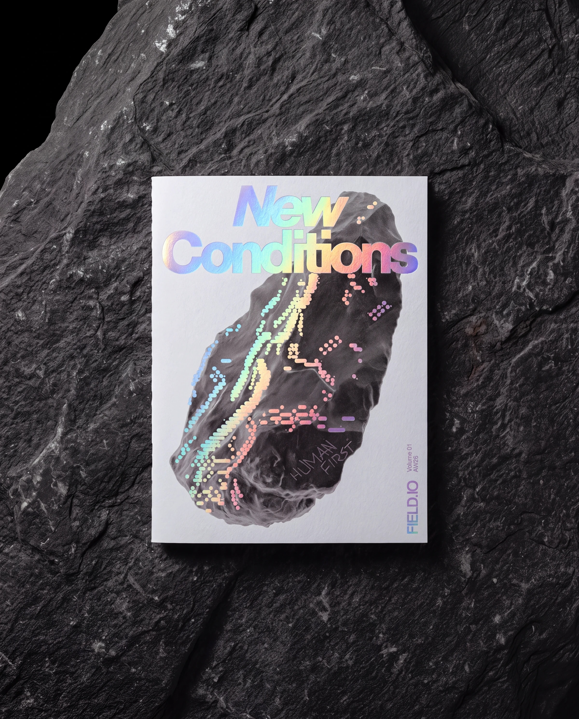 New Conditions, Volume 01 — Human First, photographed on dark rock